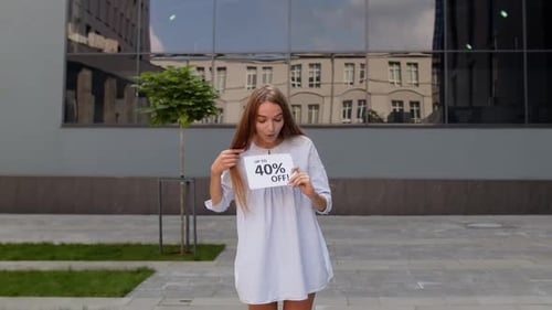 Enthusiastic Young Woman Promoting Big Sales in City