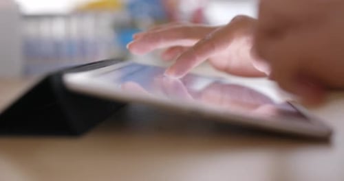 Working on digital tablet computer at home
