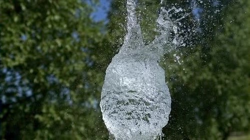 Blue Water Balloon Exploding in Slow Motion