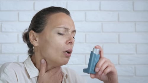 Woman Using Inhaler for Asthma Attack