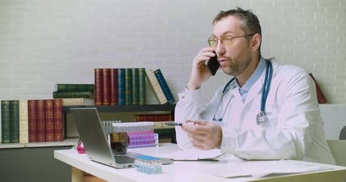 Doctor Talking on Phone in Office