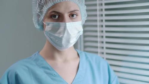 Female Hospital Worker in Protective Uniform Posing for Camera