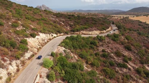 Aerial Shot of Electric Car Driving on the Sunny Road Highway to Mountains Landscape