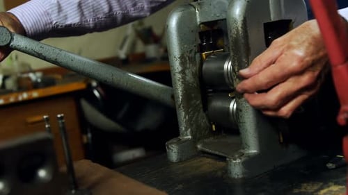 Goldsmith working on machine in workshop 4k