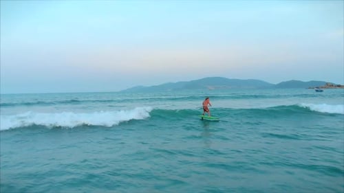 Surfer Rides Ocean Wave on Sunny Day