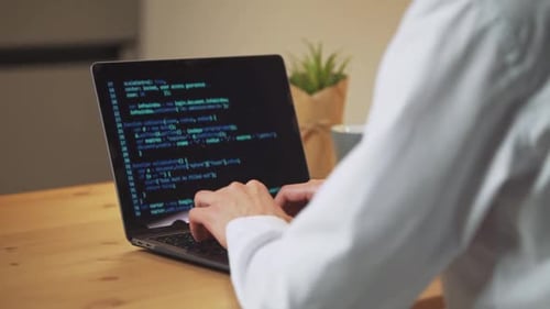 Male Programmer is Working on Creating Software Typing Program Code on a Laptop Keyboard Programmer