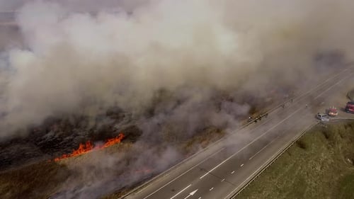 Grass Field Fire Burns Near Rural Highway
