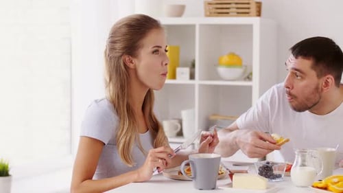 Young Couple Enjoying Breakfast at Home Together