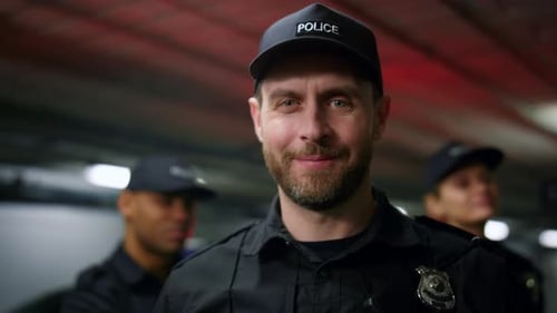 Smiling Police Officer Standing With His Team