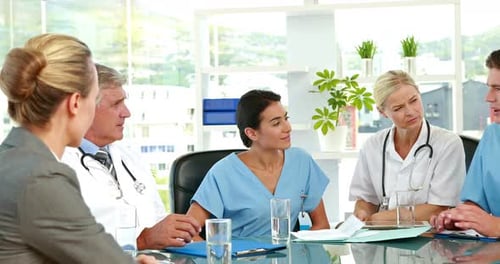 Doctors in Meeting Discussing Medical Documents