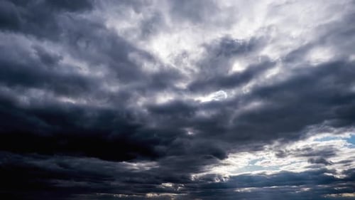 Amazing Dramatic Storm Clouds Move in the Blue Sky. Time Lapse. Sunbeams Shine.