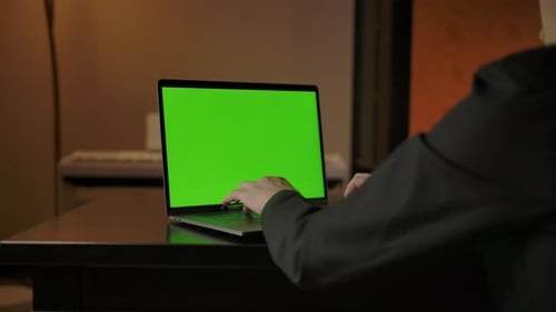Man Typing on Laptop Keyboard with Green Screen Fast Dolly in Shot