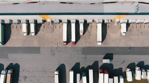 Lorry Drives Past Trucks Standing Near Huge Warehouse Ramps