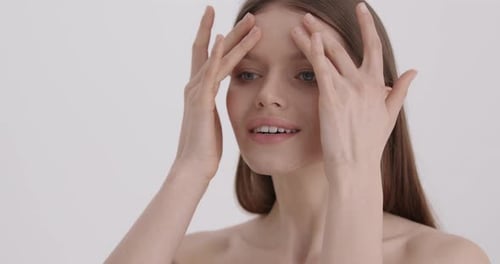 Woman Applying Beauty Product to Face