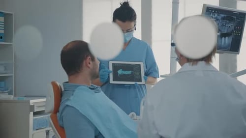 Dentist Explaining X-Ray to Patient with Tablet