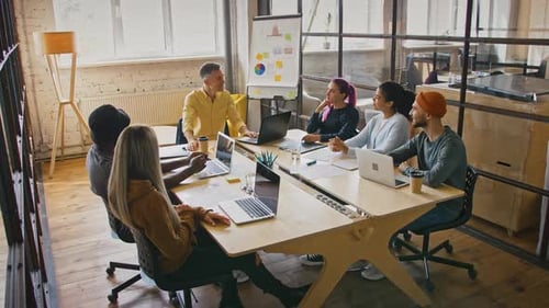 Diverse Team Collaborating at Modern Office Meeting