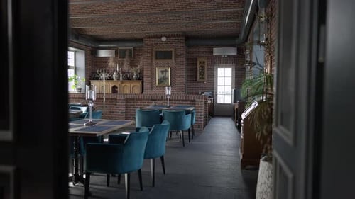 Wide Shot Interiors of Luxurious Restaurant with Joyful Interracial Couple Sitting at Table Laughing