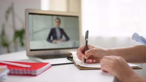 Young Adult Attends Virtual Meeting and Takes Notes