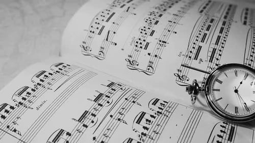 Elegant Pocket Watch Resting on Open Music Sheet