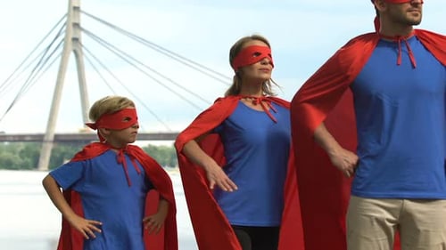 Superhero Family Poses in Front of City Bridge