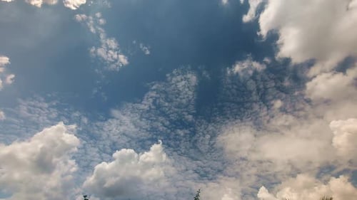 White Clouds Moving Across a Blue Sky Time Lapse