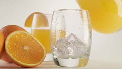 Fresh Orange Juice Being Poured Over Ice