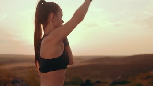 Young Woman Practicing Boxing Outdoors at Sunrise
