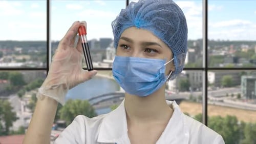 Young Adult in Medical Lab Holding Test Tube