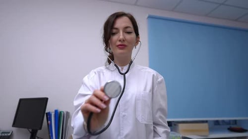 Doctor Holds Stethoscope in Bright Medical Office