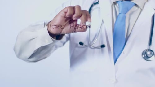 Doctor Writes Micro Plastics on Clear Surface