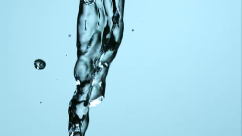 Abstract Water Pouring Against Light Blue Background