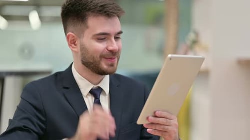Professional Man on Video Call with Tablet