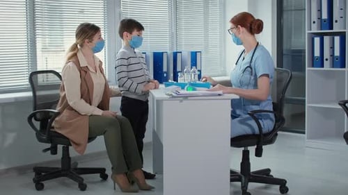 Doctor Consults With Child Patient in Clinic