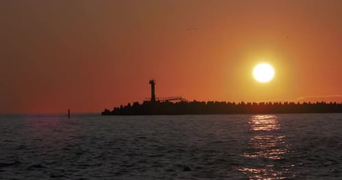 Lighthouse Silhouette at Sunset on the Ocean
