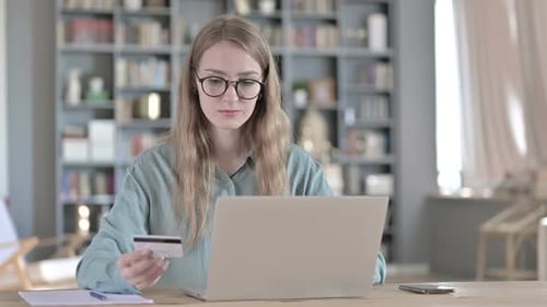 Woman Shopping Online With Credit Card and Laptop