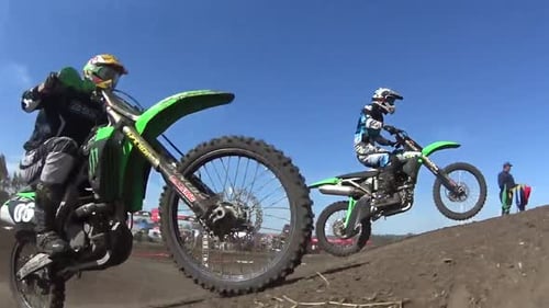Motocross Riders Racing on Dirt Track and Jumps