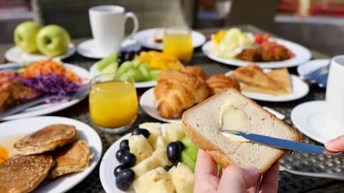 Rich Breakfast Food Spread with Toast and Fruits