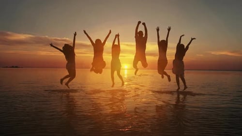 Beach vacations concept. Beauty and joyful teenager friends having fun, dancing, spraying over summe