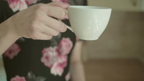 Woman Enjoys Drinking Coffee at Home