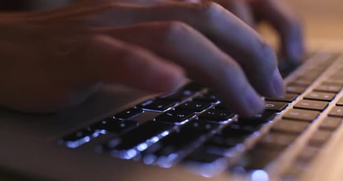 Typing on laptop computer