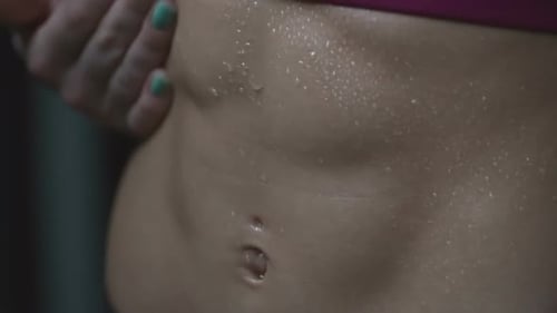 Woman's Sweaty Abs After Intense Workout
