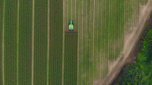 Aerial View of Tractor Working a Green Field
