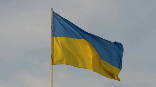 Ukrainian Flag Waving in Blue Sky