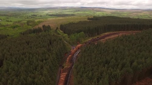 Forestry and logging operations taking place in the highlands of Scotland using large industrial mac