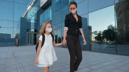 Adult Woman in Classic Clothes Holds Little Girl in Dress By Hand, Talking Together, Walking Down