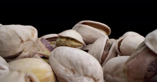 Pile of Pistachios Against Black Background
