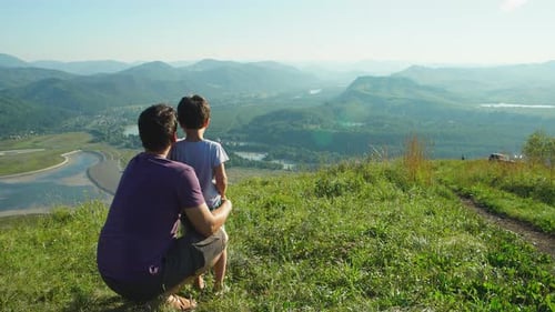 Father and Son Admiring Mountain Viewpoint