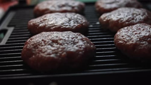 Burger Patties Cooking on a Grill Close Up