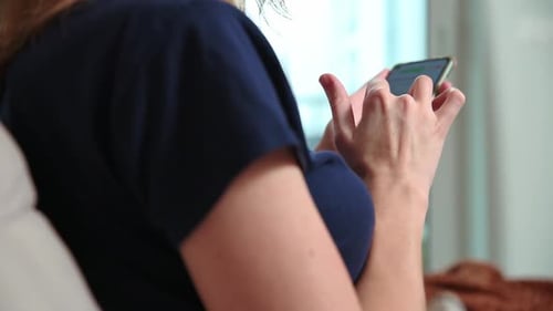 Woman Using Mobile Phone Indoors Close Up