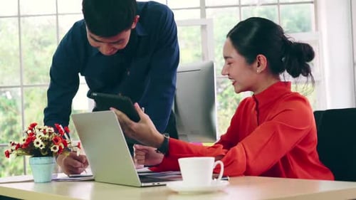 Two Business People Talk Project Strategy at Office